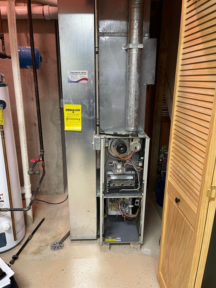 An indoor furnace and air handler unit with exposed components, showing an HVAC job by ACW Heating & Air in North Aurora, IL