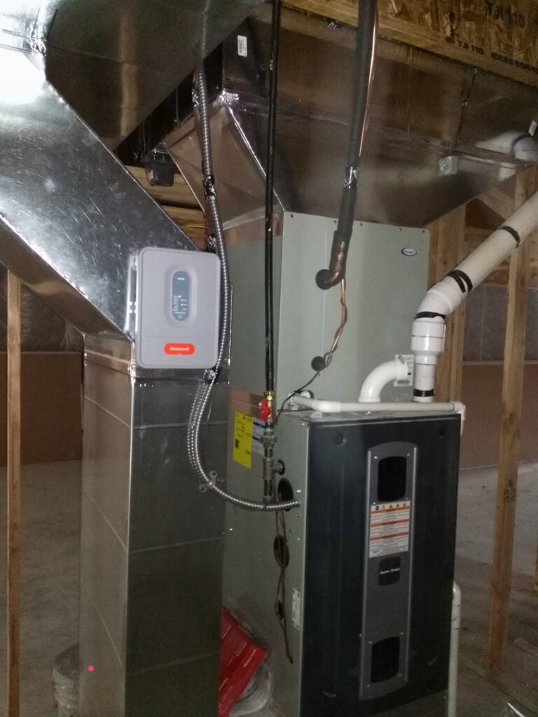 A furnace and air handler unit with ductwork and a Honeywell control box, installed by Jv Services inc. in Pinellas Park, FL.