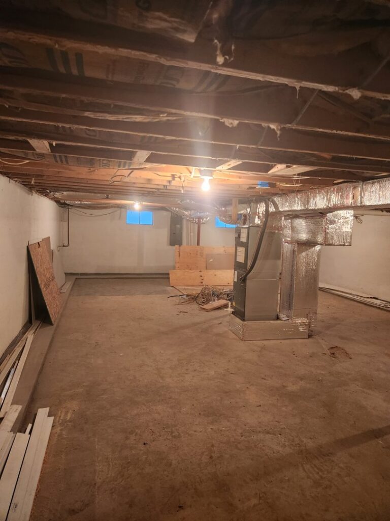 New furnace and air handler unit with ductwork installed in a basement by Duct Pros in Martinsburg, WV