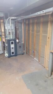 A new furnace and air handler unit installation in a basement by Hampden County HVAC Inc. in Indian Orchard, MA