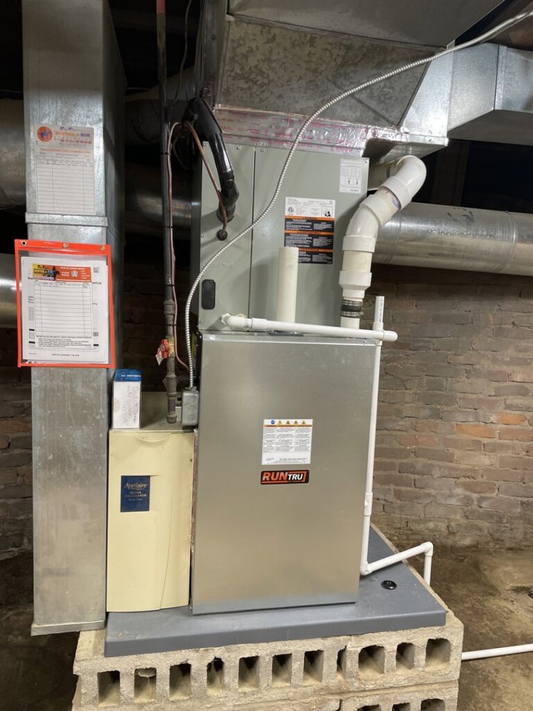 A furnace and air handler unit installed in a basement by Roy Rogers Heating and Air in Indianapolis, IN.