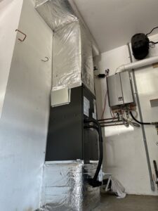 Indoor furnace or air handler unit with insulated ductwork installed by GreenFlow Heating & Cooling in Tacoma, WA