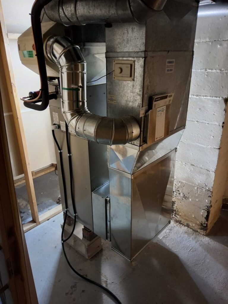 A furnace and air handler unit installed in a basement by Nimmer Heating & Air Conditioning in Milwaukee, WI.