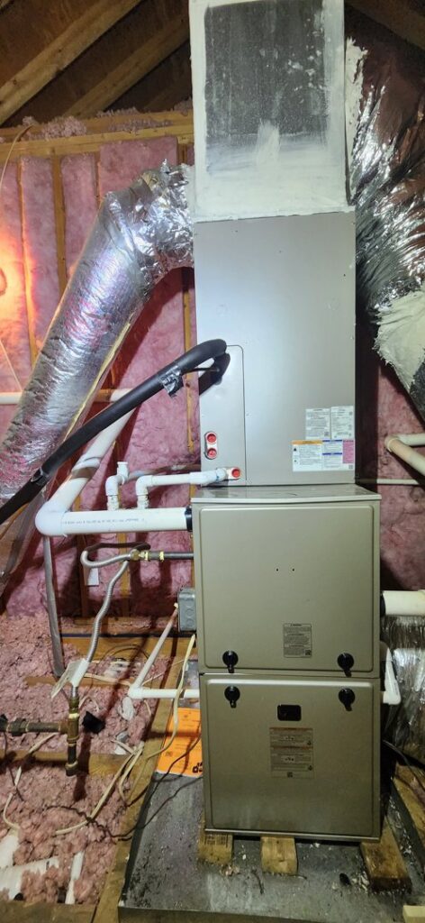 A furnace and air handler unit with ductwork installed in an unfinished space by Recovery HVAC in Smyrna, TN.