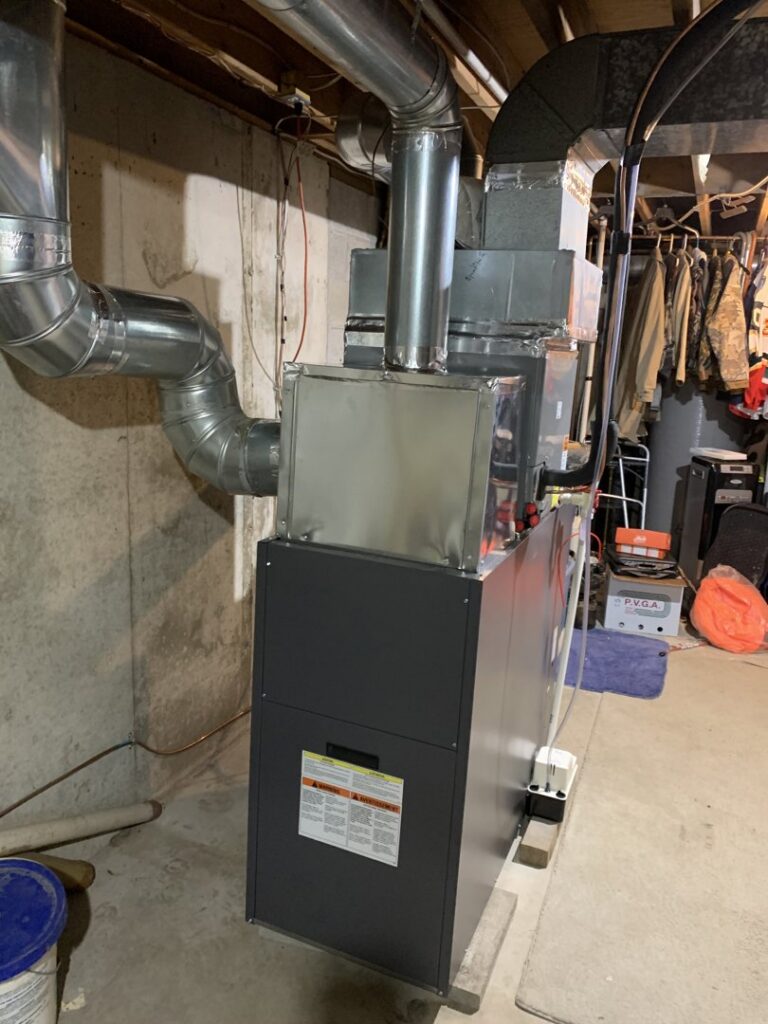 A new furnace or air handler unit with ductwork installed in a basement by Superior CO-OP HVAC in Cambridge, NY.