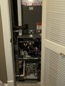 An HVAC furnace and air handler unit installed in a utility closet by York's Quality Air in Indianapolis, IN.