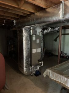 A furnace and air handler unit with insulated ductwork installed in a basement by MTL Heating and Cooling LLC in West Haven, CT