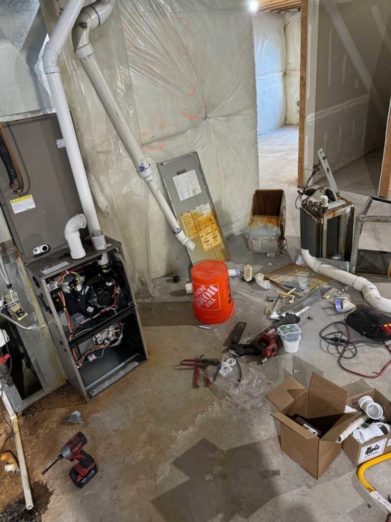An indoor furnace or air handler unit undergoing repair or installation by Diamond L Plumbing & HVAC in Salt Lake City, UT.