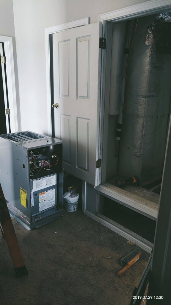 An indoor furnace or air handler unit with its front panel removed for service by Aircon Heating and Cooling Inc in Las Cruces, NM