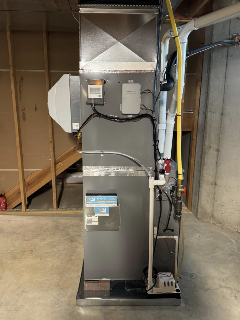 A new furnace or air handler unit with attached humidifier and ductwork installed by Vai Services in Wilmington, DE.