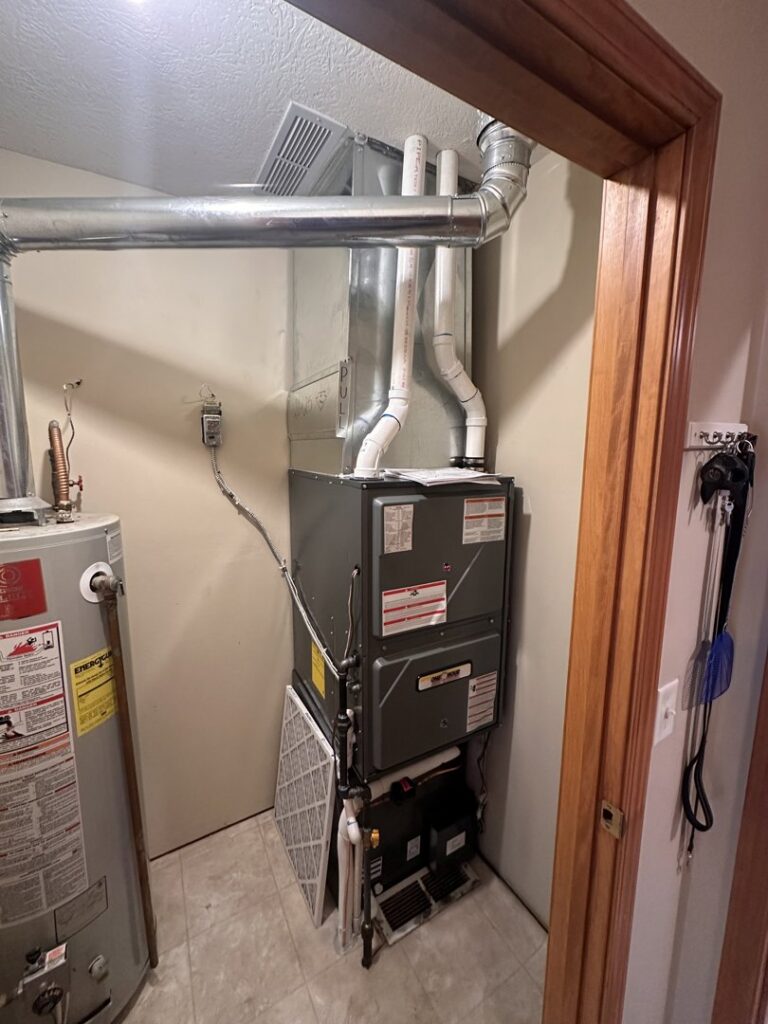A furnace and air handler unit with a visible filter, serviced by One Hour Heating & Air Conditioning of Springfield in Springfield, MO.