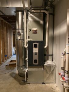 A new furnace with an attached air purifier and ductwork installed during construction by Climate Control Experts HVAC LLC in Federal Way, WA