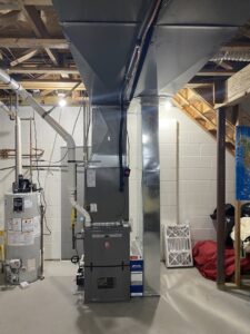 A modern furnace and extensive ductwork system installed in a basement by Air We Are in Toms River, NJ.