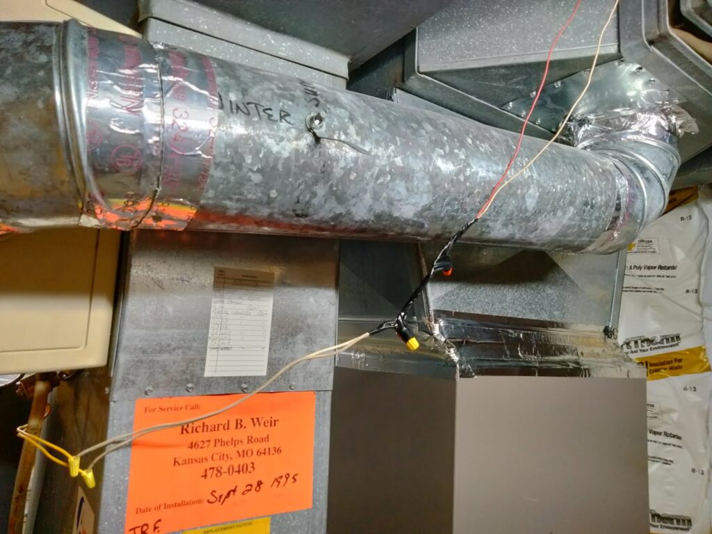 An installed furnace and ductwork system with a service label by Avery Heating and Cooling in Independence, MO.