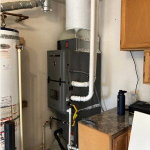 A furnace and water heater installed in a utility area by DiMartino's 5 Star Heating & Air Conditioning LLC in Salem, OR.