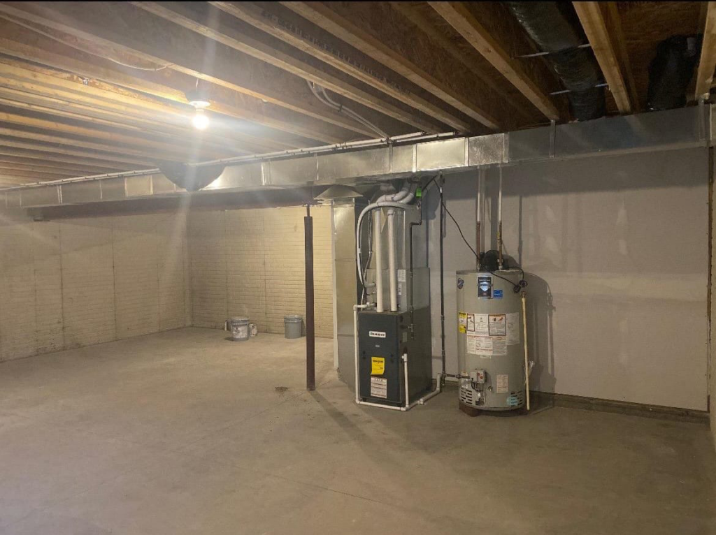 A furnace and water heater installed in a basement by Embassy Heating and Air Conditioning in Toledo, OH