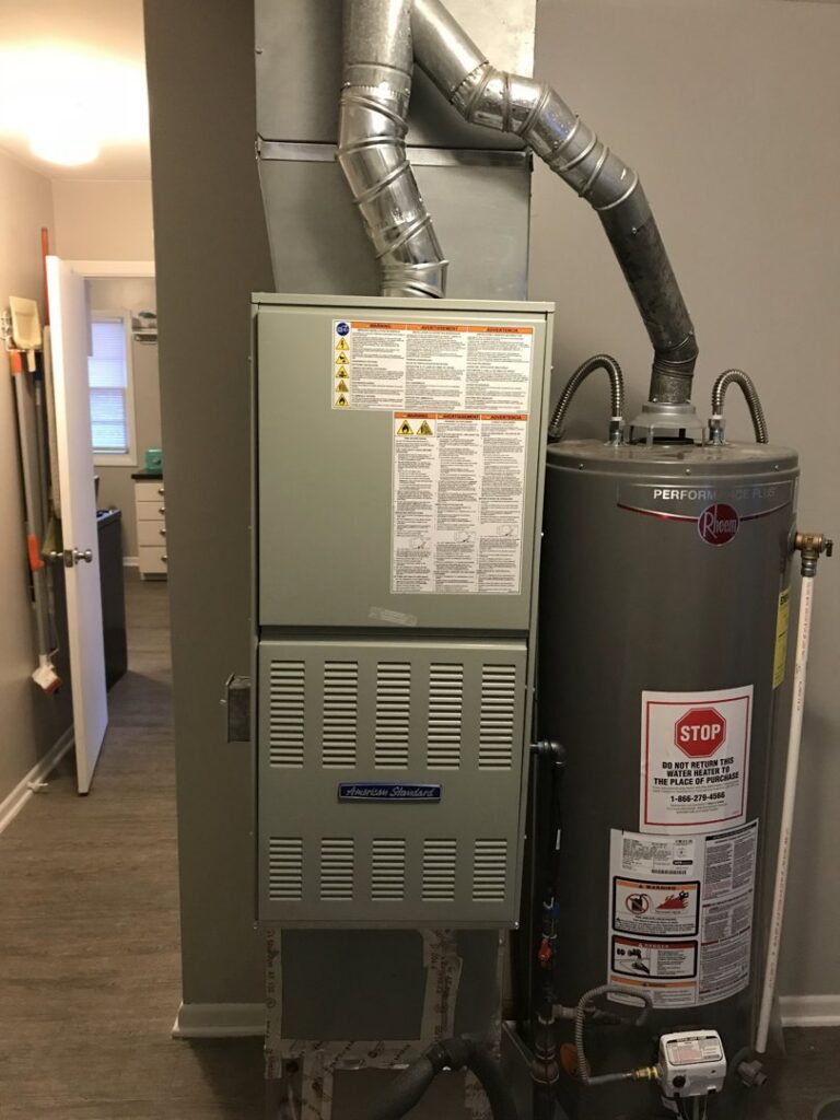 A furnace and water heater installed in a utility area by Epic Heating & Cooling in Wichita, KS.