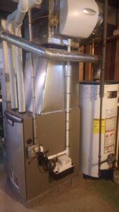 A furnace and water heater installed in a basement by Falso Service Experts in East Syracuse, NY.