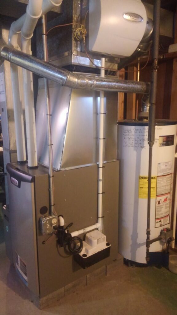 A furnace and water heater installed in a basement by Falso Service Experts in East Syracuse, NY.