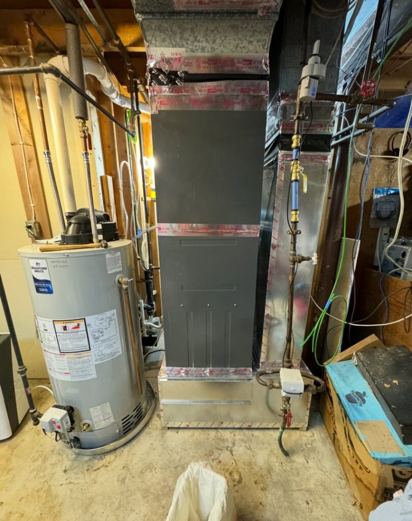 A furnace and water heater installation in a utility area by HVAC KING LLC in Maple Grove, MN
