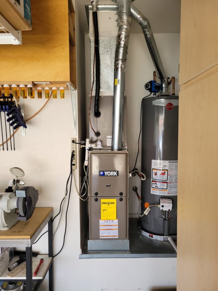 A new furnace and water heater installed in a utility closet by J & M Cooling & Heating LLC in Peoria, AZ.