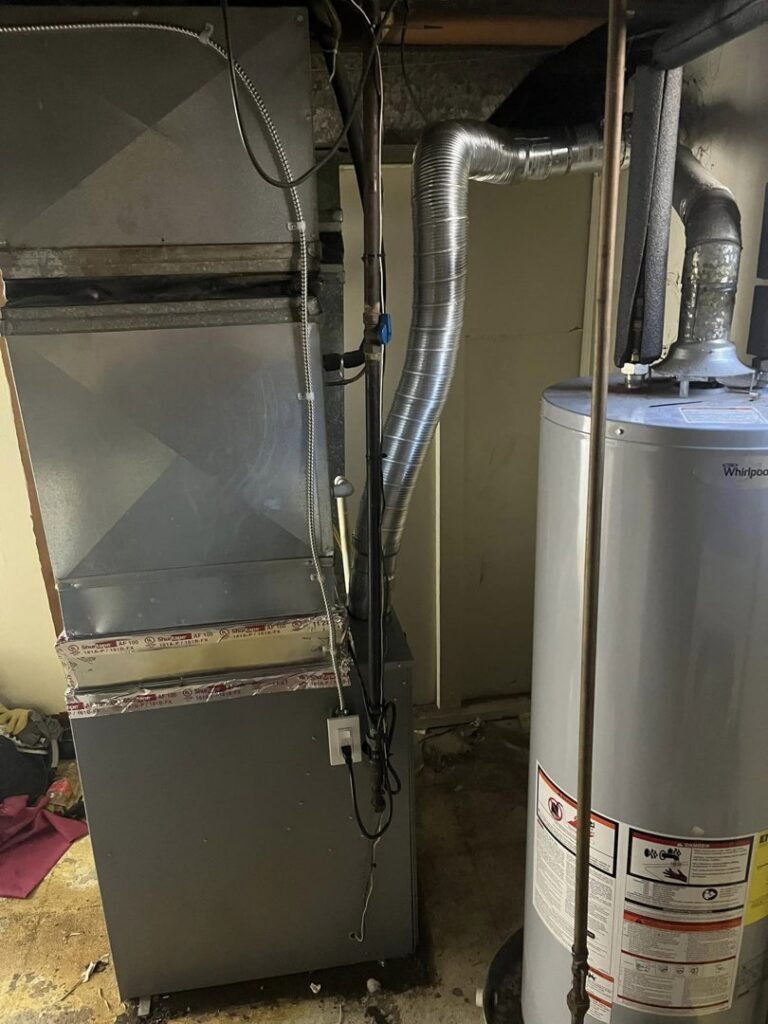 An indoor furnace and water heater installation with ductwork by Motown Mechanical Heating And Cooling in Westland, MI.