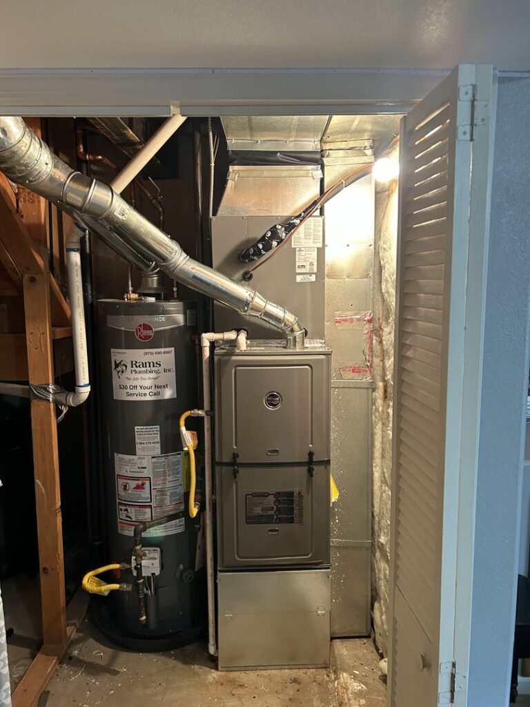 A new furnace and water heater installation in a utility closet by R&R Mechanical Services in Greeley, CO.