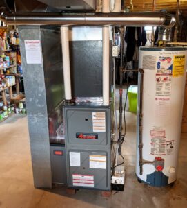 An indoor furnace and water heater installation by Total Comfort Heat and Air Conditioning, Inc. in Rochester, NY.