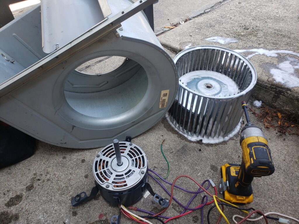 A disassembled furnace blower motor and fan during repair by Brothers Heating & Cooling Inc. in Chicago, IL.