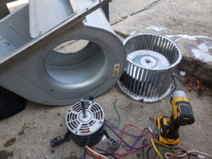 A disassembled furnace blower motor and fan during repair by Brothers Heating & Cooling Inc. in Chicago, IL.