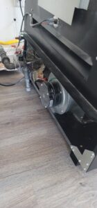 Close-up view of a furnace's internal blower motor and gas lines, indicating HVAC service by Northern Peak Heating & Cooling in Bozeman, MT.