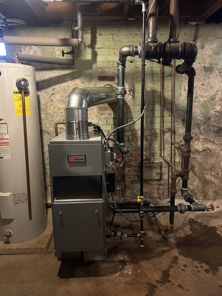 A furnace or boiler unit with piping and a water heater in a basement, installed by Express Home Services LLC in Las Vegas, NV.