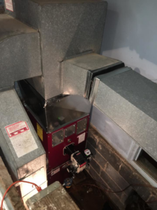 A furnace or boiler unit with connected metal ductwork installed by MTL Heating and Cooling LLC in West Haven, CT