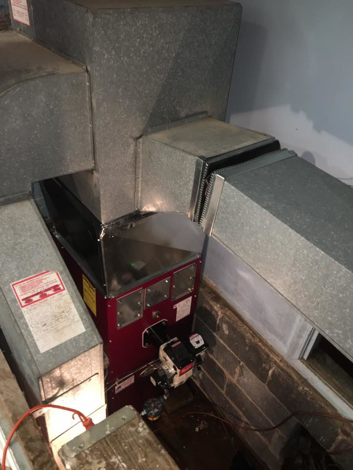 A furnace or boiler unit with connected metal ductwork installed by MTL Heating and Cooling LLC in West Haven, CT