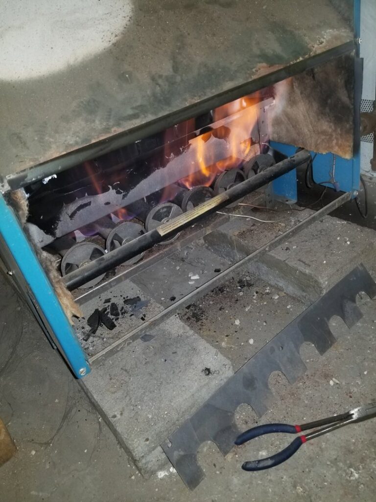 Furnace burner flames visible during a service check by HVAC Royal Service Inc in Chicago, IL.