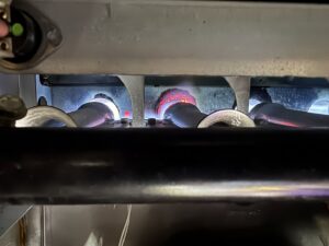 A close-up view of furnace burners in operation, serviced by Inspired Heating & Cooling, Electric, Roofing, Repair LLC in Columbus, OH.