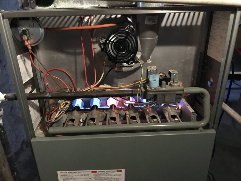 A close-up of furnace burners lit during service or testing by Modern HVAC Technology in Chicago, IL.