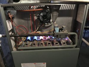 A close-up of furnace burners lit during service or testing by Modern HVAC Technology in Chicago, IL.