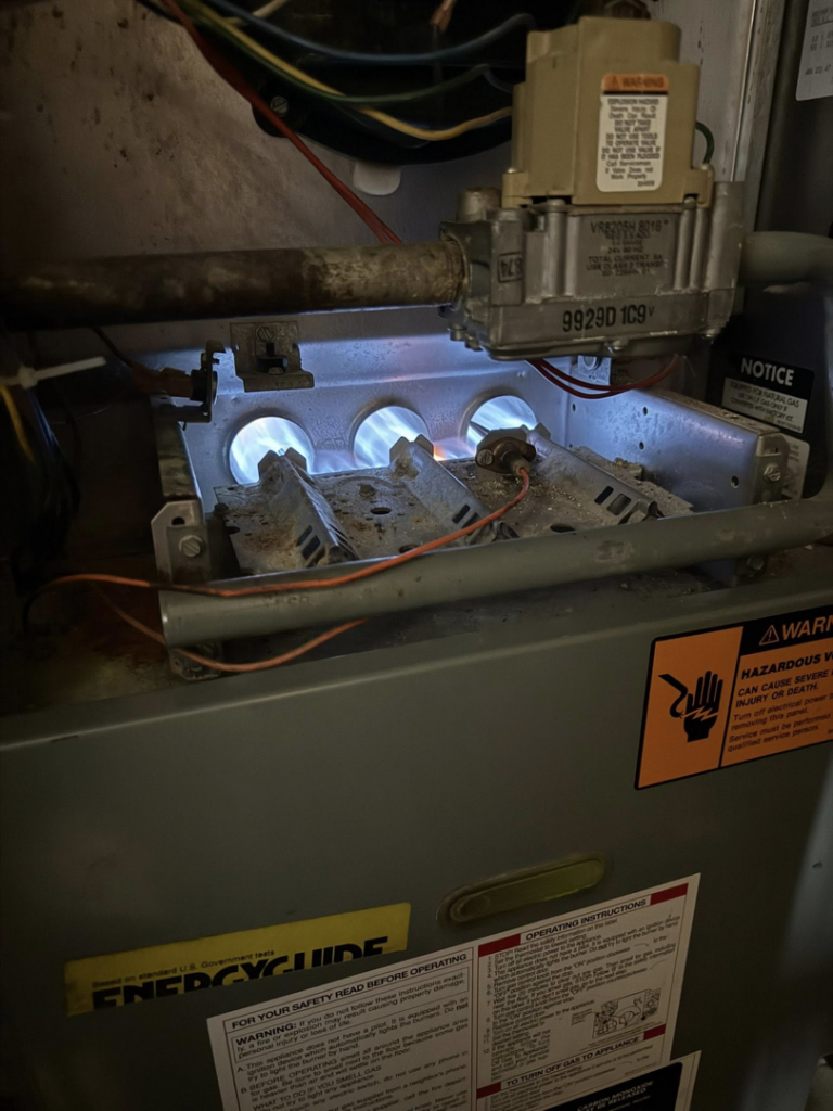 Furnace burners lit during an HVAC service call by Nacho Heating & Cooling Plus Co. in Crest Hill, IL