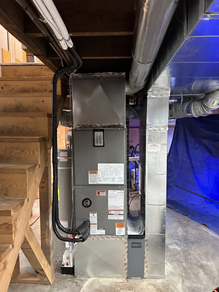 A furnace and ductwork installation in a basement utility area by A's Heating and Cooling LLC in Portland, OR.
