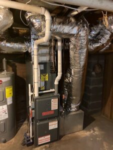 A Goodman furnace and extensive ductwork installation in a basement by Evergreen Services in Warwick, RI.