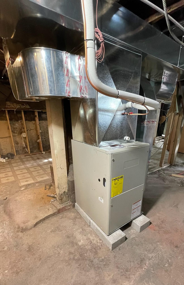 A newly installed furnace and ductwork system in a basement by JL Heating & AC LLC in Chicago, IL