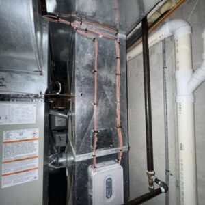 An indoor furnace unit with extensive ductwork and wiring, showcasing HVAC installation by Lopez Mechanical HVAC in Kansas City, MO.