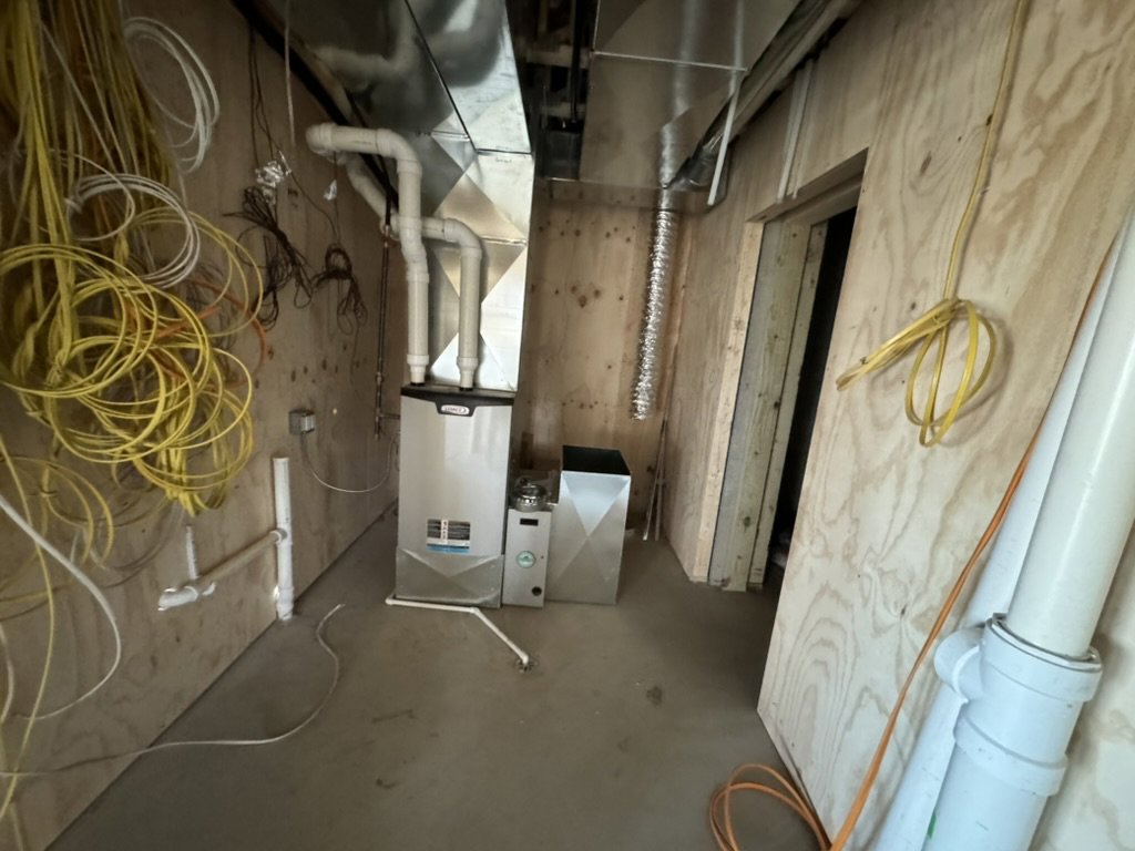 A furnace and new ductwork installed in a utility room during new construction by Dischler Heating-Cooling & Fireplaces in Prairie du Sac, WI.