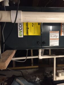 A close-up of an indoor furnace unit showing its EnergyGuide label, installed by Butte Heating & Cooling in Rapid City, SD.