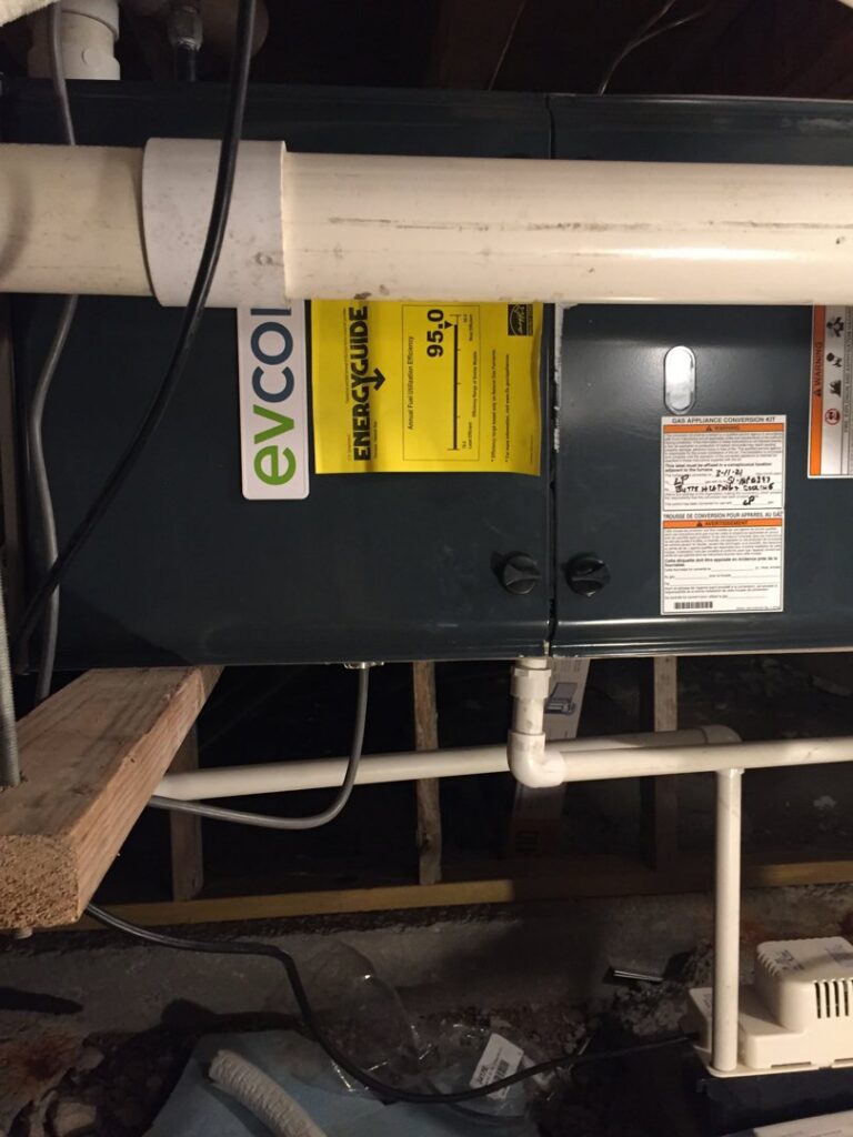 A close-up of an indoor furnace unit showing its EnergyGuide label, installed by Butte Heating & Cooling in Rapid City, SD.