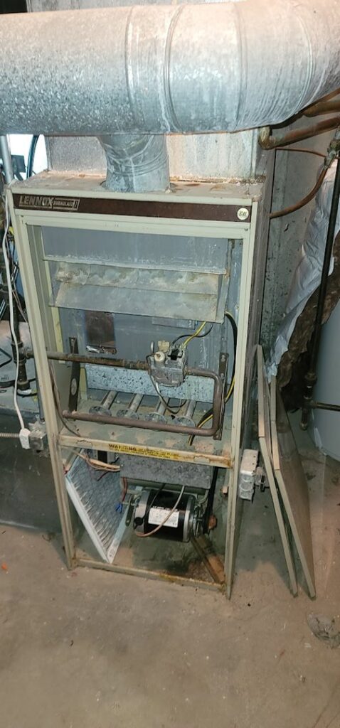An open Lennox furnace unit showing internal components and a filter during service by Northern Peak Heating & Cooling in Bozeman, MT.