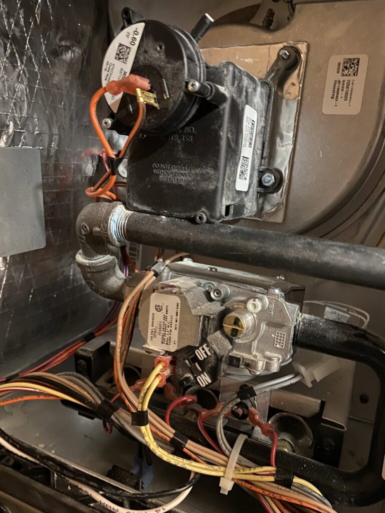 Close-up of a furnace gas valve and wiring during an inspection by Service Experts Denver in Westminster, CO