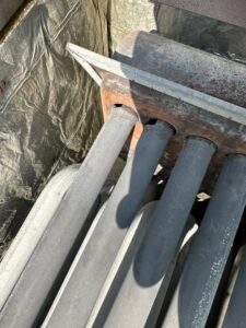 Close-up of furnace heat exchanger tubes, indicating inspection or repair services by All Around Heating & Cooling in Akron, OH.