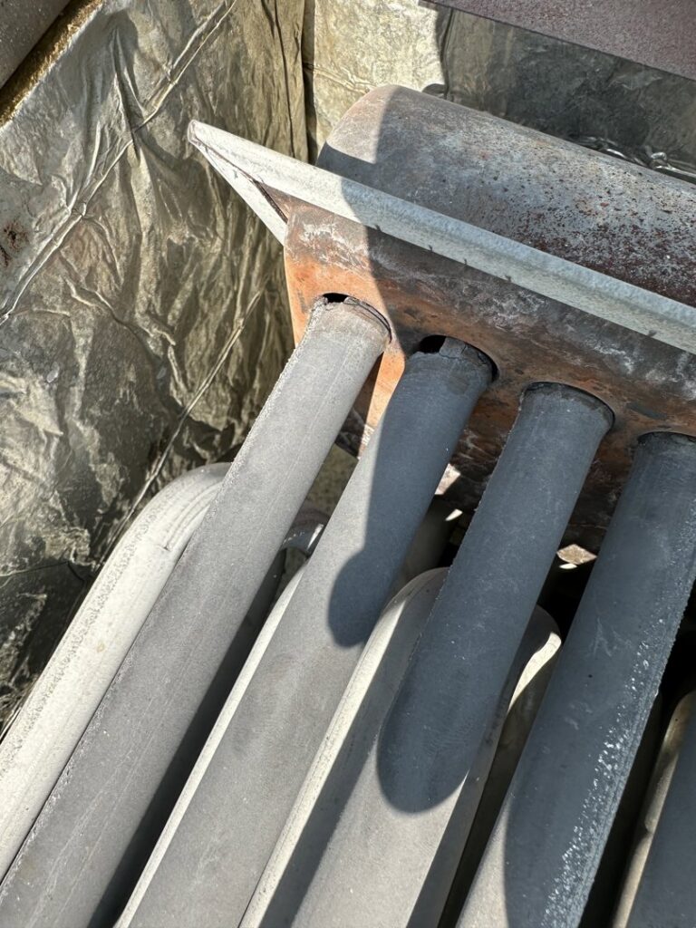 Close-up of furnace heat exchanger tubes, indicating inspection or repair services by All Around Heating & Cooling in Akron, OH.